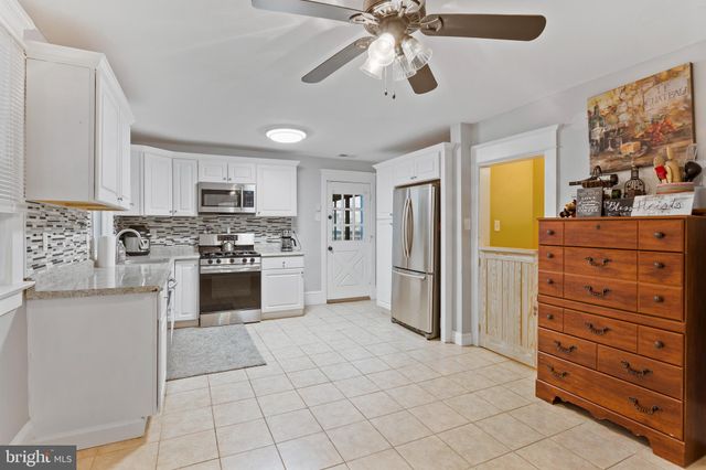 a kitchen with stainless steel appliances a refrigerator sink and stove