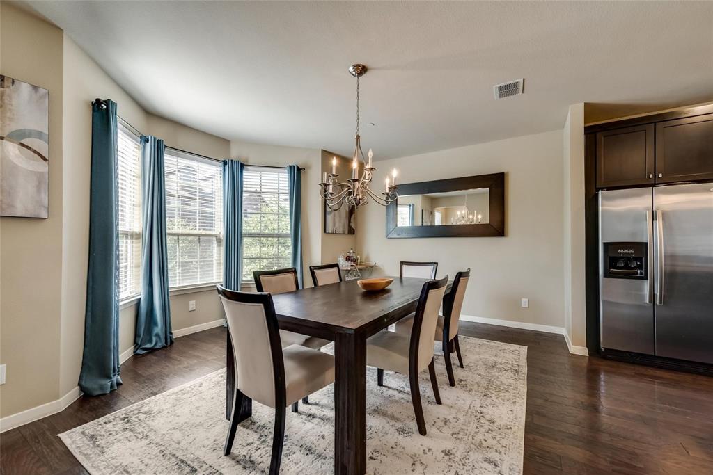 3943 Asbury Lane Addison, TX 75001 - Photo 12 of 29 a dining room with furniture a chandelier and wooden floor