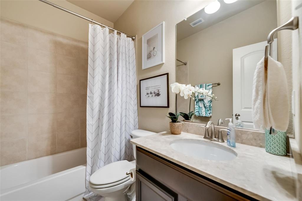3943 Asbury Lane Addison, TX 75001 - Photo 16 of 29 a bathroom with a granite countertop sink toilet and shower