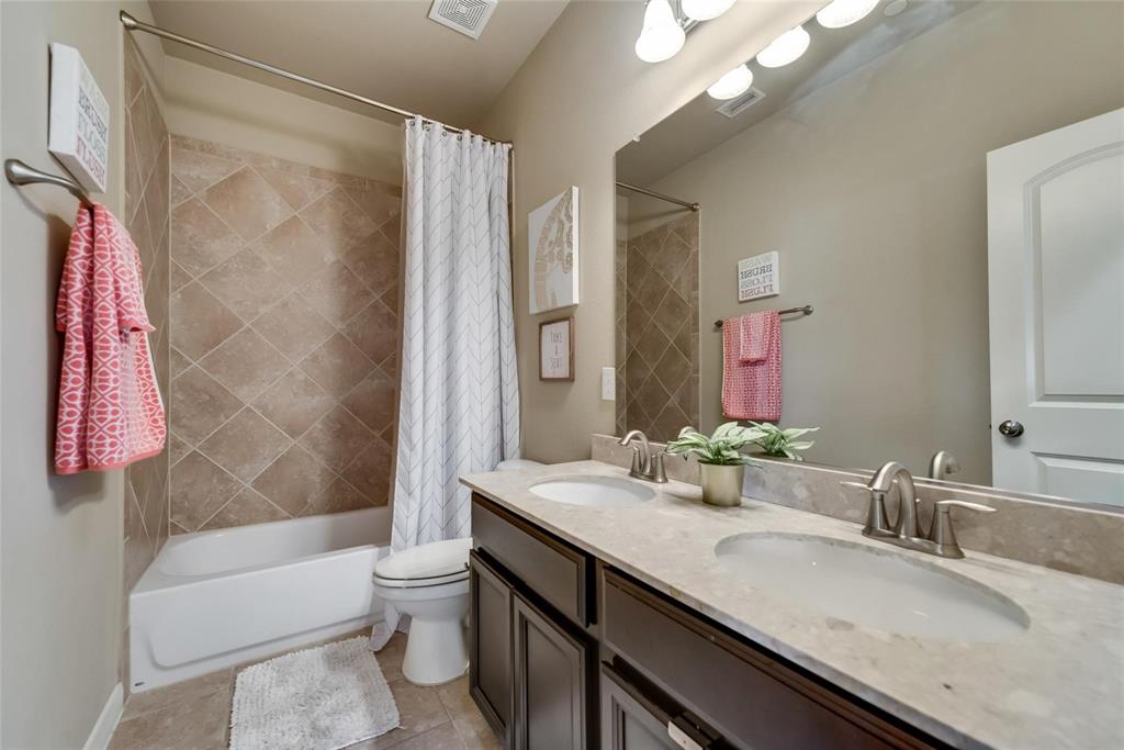 3943 Asbury Lane Addison, TX 75001 - Photo 19 of 29 a bathroom with a granite countertop sink toilet and shower