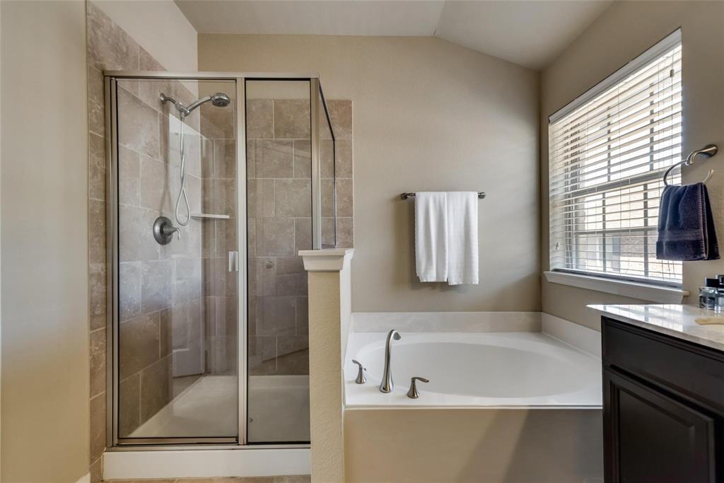 3943 Asbury Lane Addison, TX 75001 - Photo 22 of 29 a bathroom with a bathtub and a shower