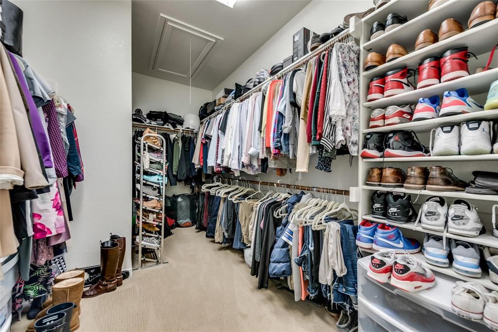 3943 Asbury Lane Addison, TX 75001 - Photo 23 of 29 a view of walk in closet with clothes and shoes
