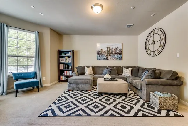 a living room with furniture and a rug