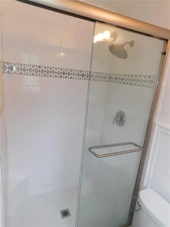 a bathroom with a glass shower door