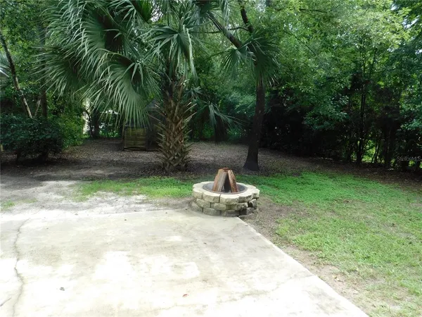 a green field with some trees in the background