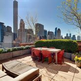 a view of a patio with couches table and chairs and potted plants