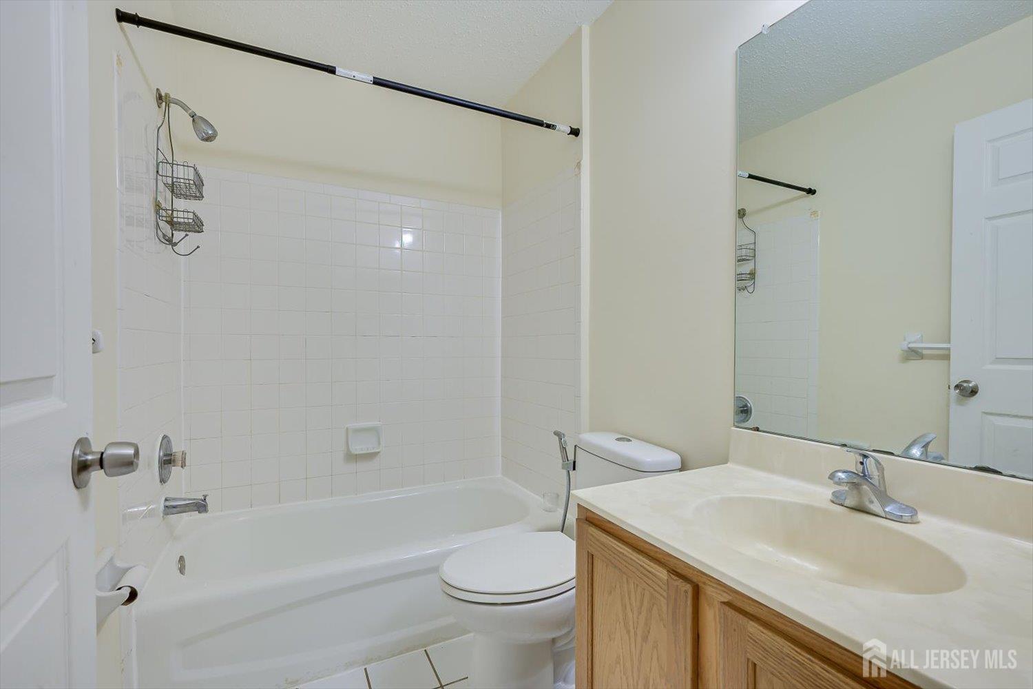 27 Edinburgh Court Edison, NJ 08820 - Photo 12 of 15 a bathroom with a sink a toilet and shower