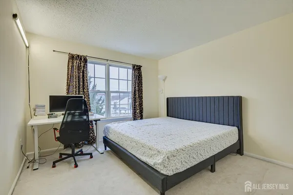 a bedroom with a bed and a desk