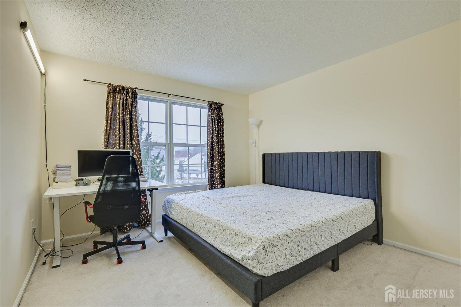 27 Edinburgh Court Edison, NJ 08820 - Photo 15 of 15 a bedroom with a bed and a desk