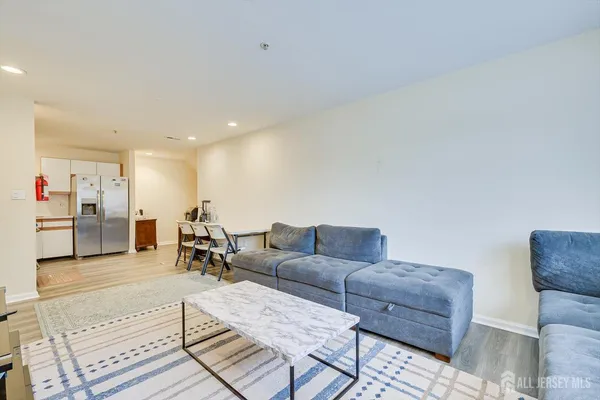 a living room with furniture and kitchen view