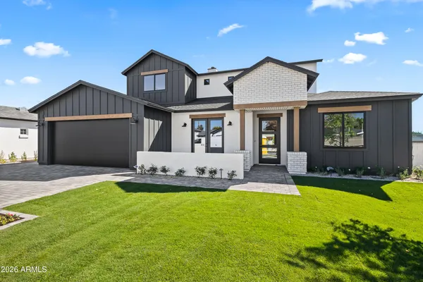 a front view of a house with a yard and garage