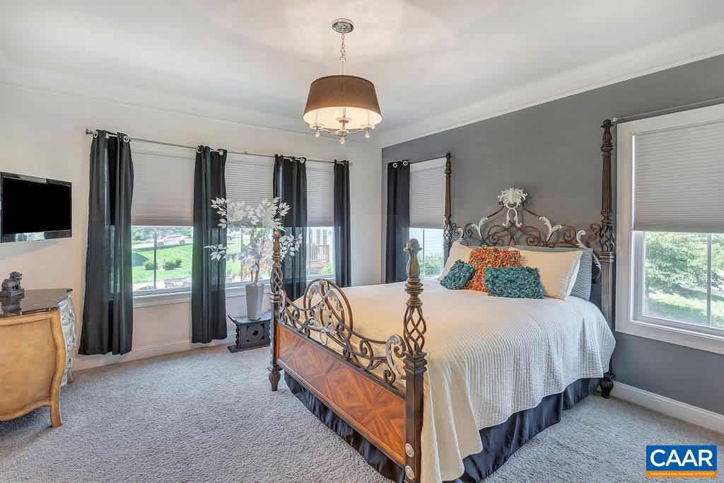 2059 Avinity Loop Charlottesville, VA 22902 - Photo 19 of 40 a bedroom with a bed and a chandelier