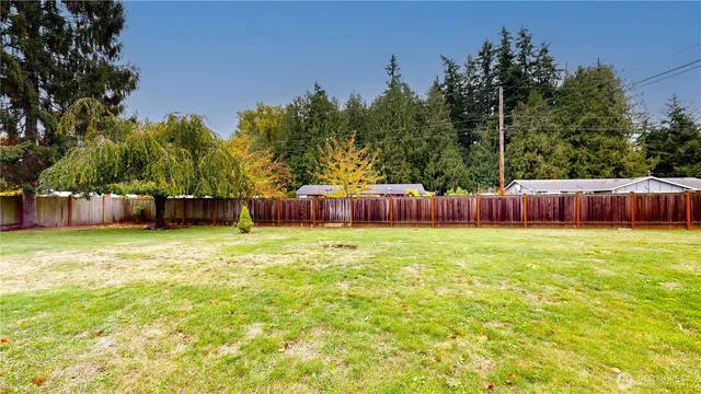 a backyard with hardwood wall fire pit and outdoor seating