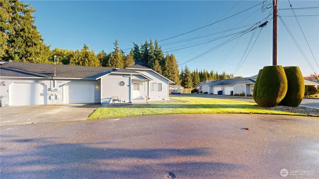a view of swimming pool with a big yard and large trees