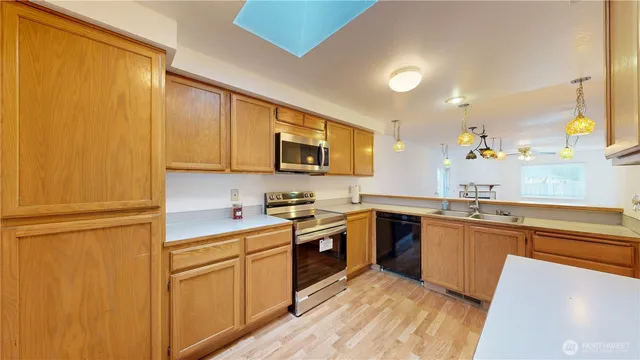 a kitchen with stainless steel appliances granite countertop cabinets and wooden floor