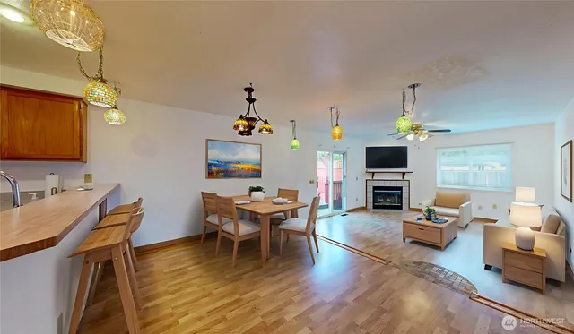 a living room with fireplace furniture and a wooden floor