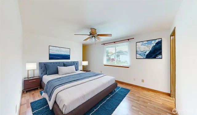 a bedroom with a bed and a painting on the wall