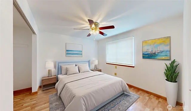 a bedroom with a bed and a potted plant