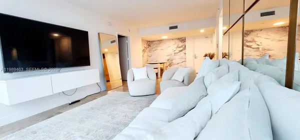 a view of living room with furniture and a flat screen tv
