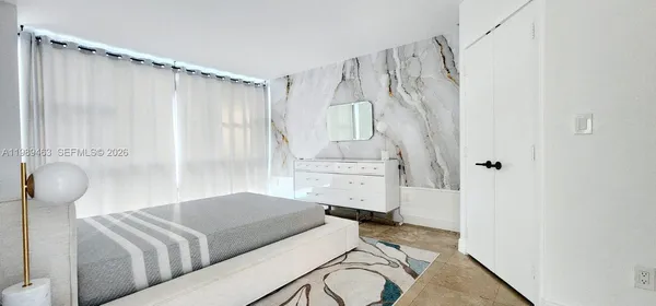 a bedroom with furniture and a shower curtain