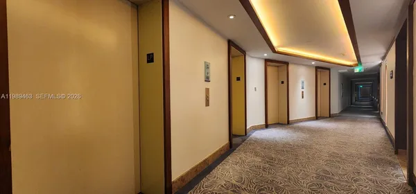 a view of a hallway with wooden shelves