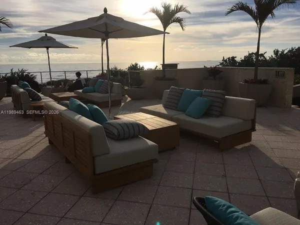 a terrace view with seating space barbeque oven and potted plants
