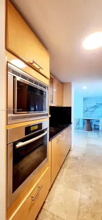 a view of kitchen with stove top oven and cabinets