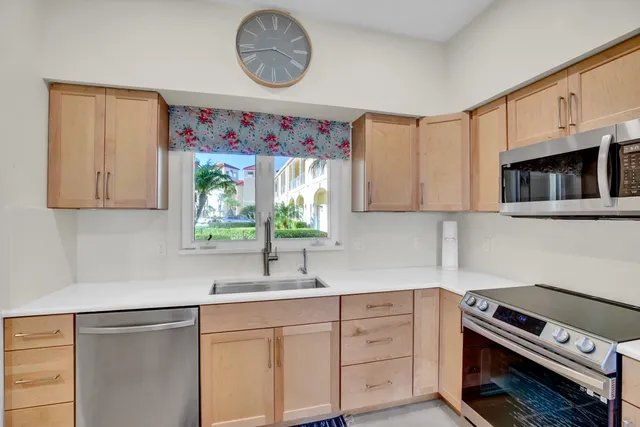 a kitchen with stainless steel appliances a stove a sink and a microwave
