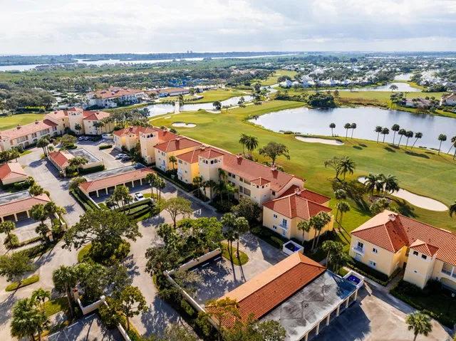 an aerial view of residential houses with outdoor space and river