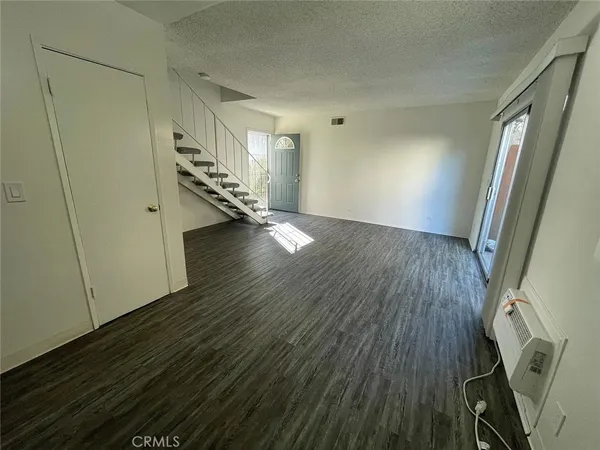 a view of entryway with stairs and wooden floor