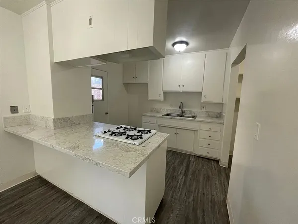 a kitchen with a sink stove and refrigerator