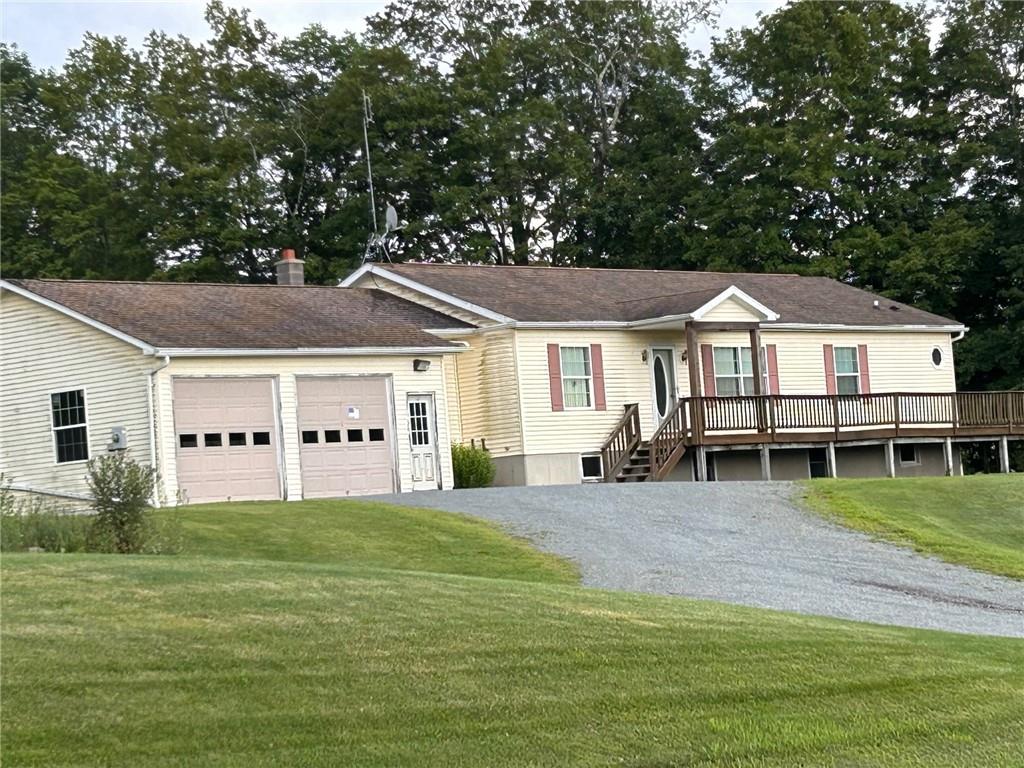 a view of a house with a big yard and large trees