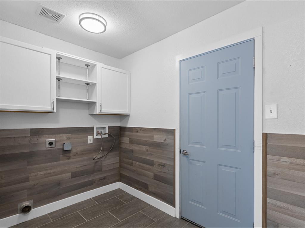 5304 Los Altos Road Fort Worth, TX 76244 - Photo 13 of 30 Washroom with cabinet space, electric dryer hookup, washer hookup, wainscoting, and a textured ceiling