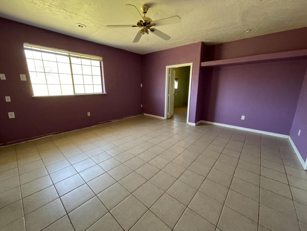 2385 Lakeview Loop Stonyford, CA 95979 - Photo 14 of 20 an empty room with windows and fan
