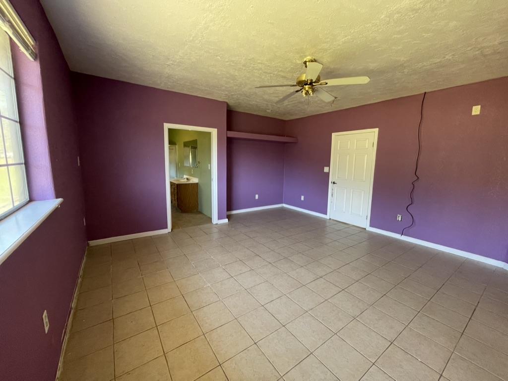 2385 Lakeview Loop Stonyford, CA 95979 - Photo 15 of 20 an empty room with windows and fan