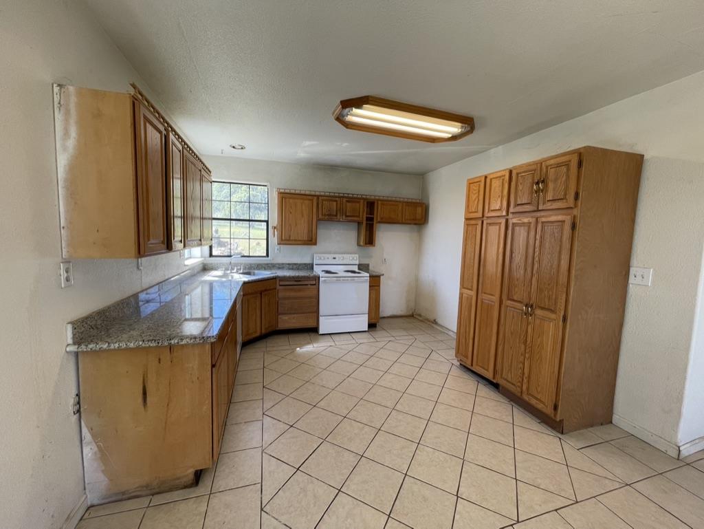 2385 Lakeview Loop Stonyford, CA 95979 - Photo 9 of 20 a kitchen with stainless steel appliances granite countertop a sink and cabinets