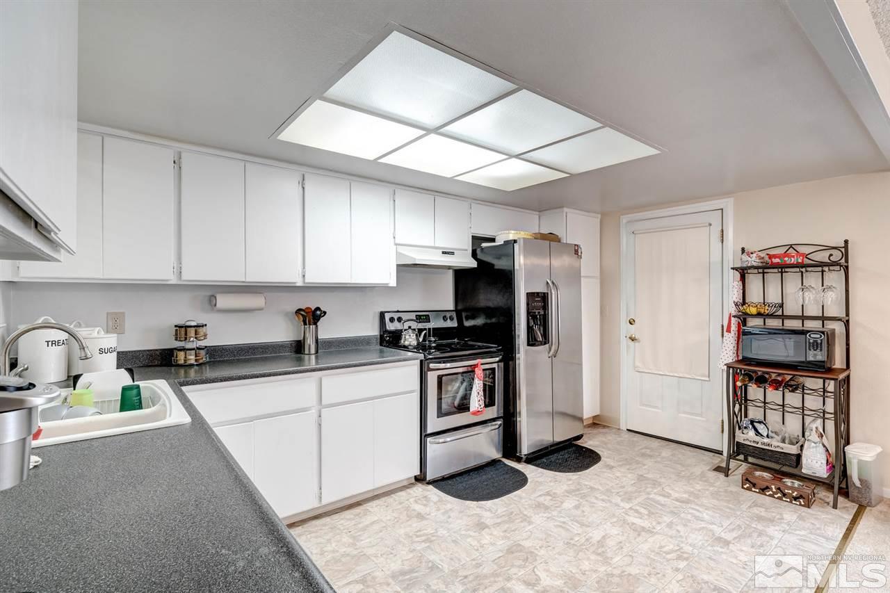 3315 Bowie Road Reno, NV 89503 - Photo 5 of 35 a kitchen with stainless steel appliances granite countertop a sink stove refrigerator and cabinets
