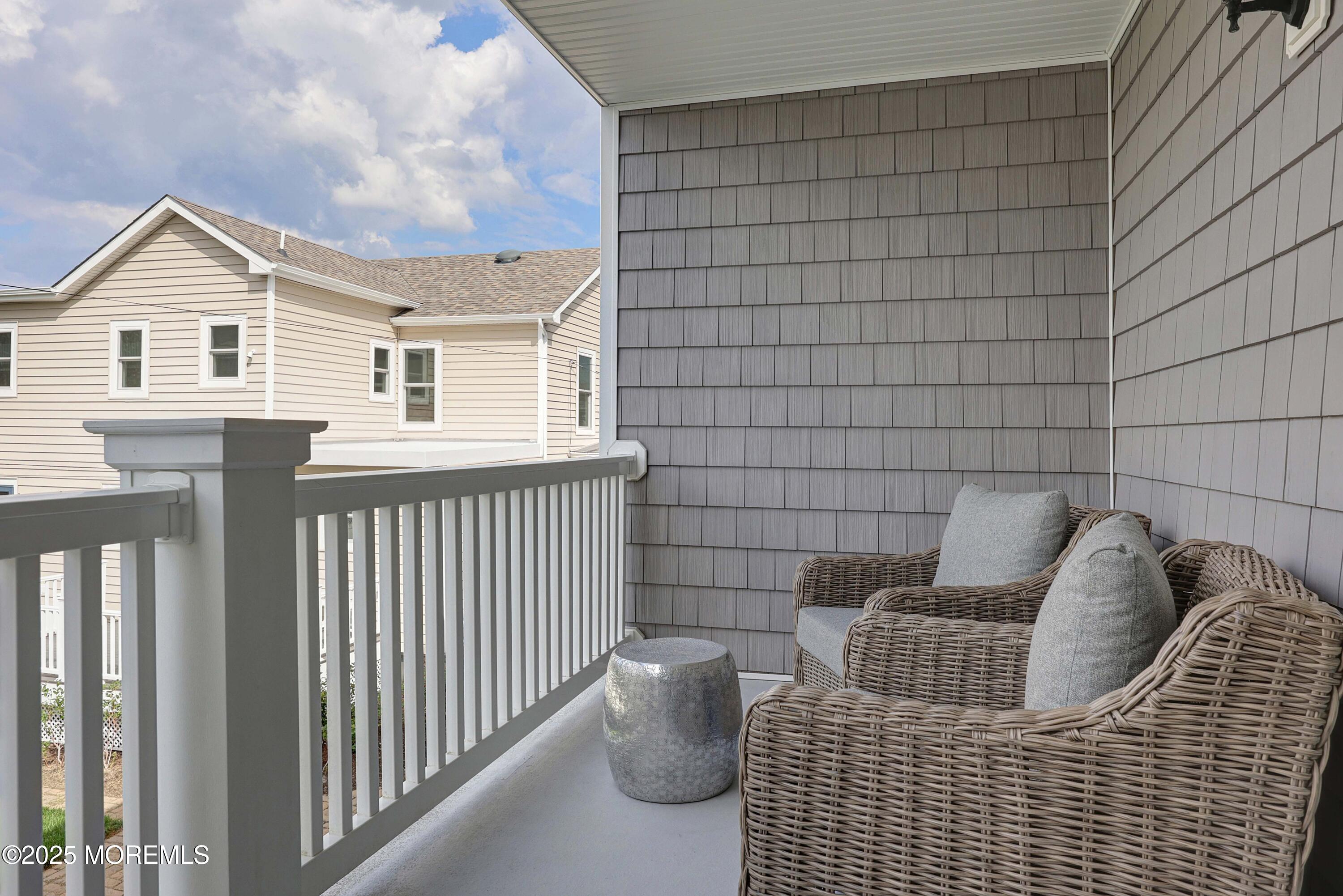 200 2nd Avenue, Unit 14 Belmar, NJ 07719 - Photo 25 of 32 a view of a chair and table in the balcony