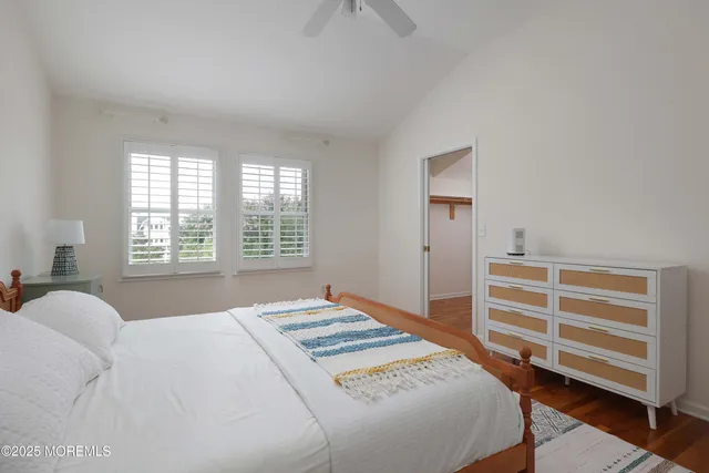 a view of a hallway with wooden floor and closet