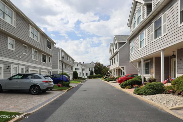 a buildings with car parked in front of it