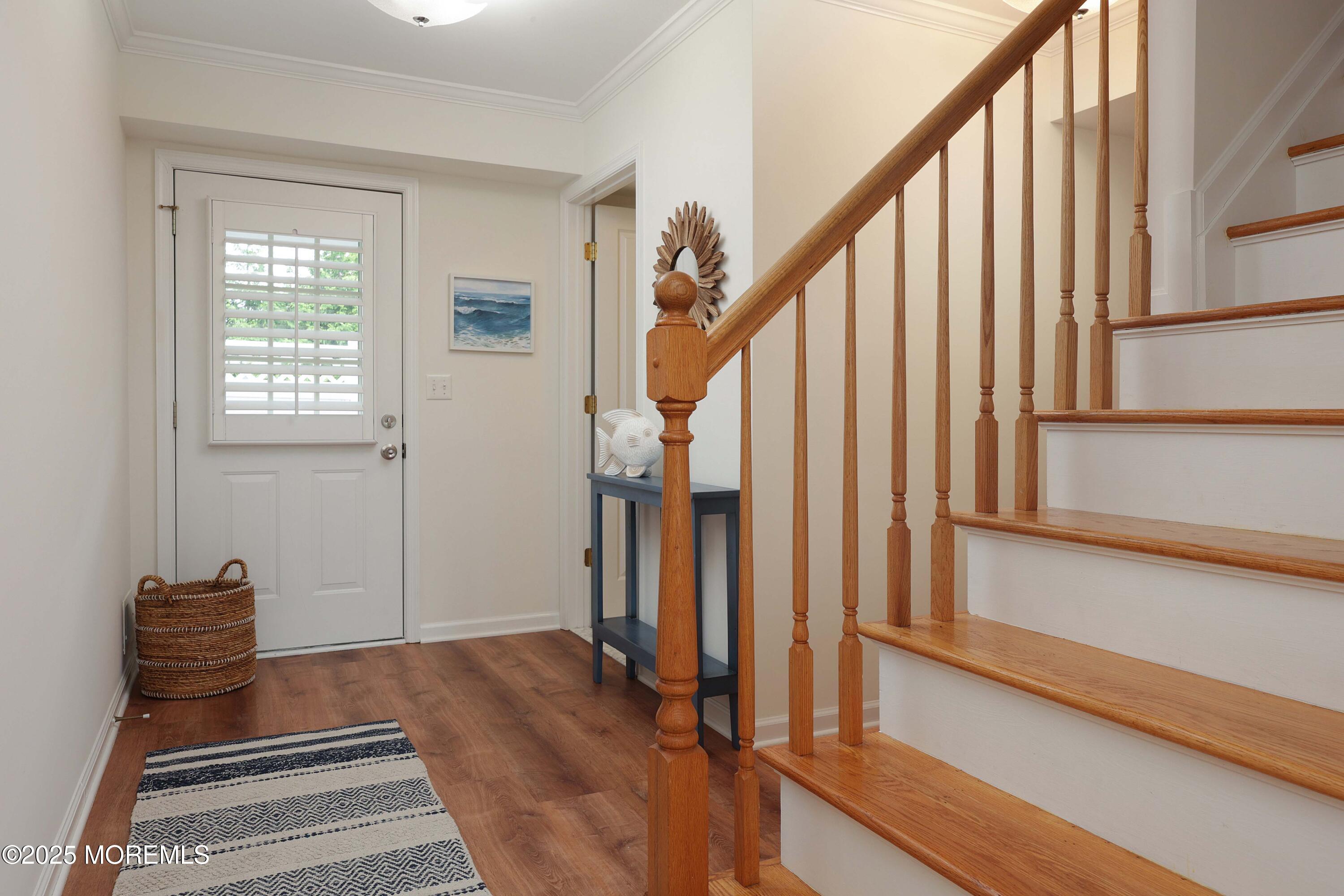 200 2nd Avenue, Unit 14 Belmar, NJ 07719 - Photo 8 of 32 a view of a hallway with wooden floor and staircase
