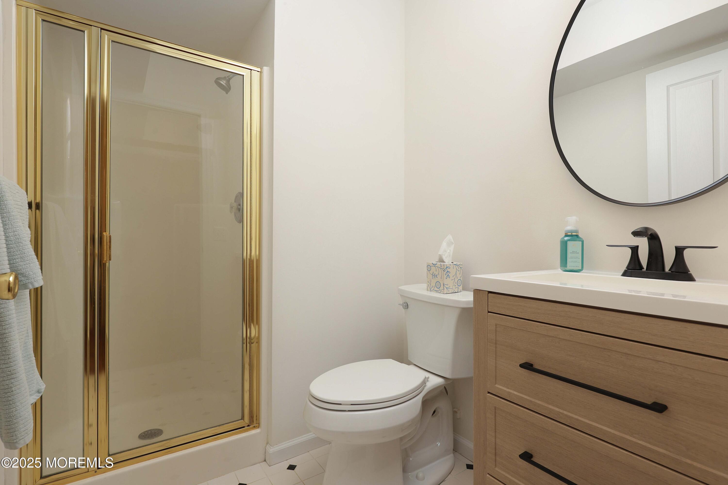 200 2nd Avenue, Unit 14 Belmar, NJ 07719 - Photo 10 of 32 a bathroom with a granite countertop sink mirror vanity and toilet