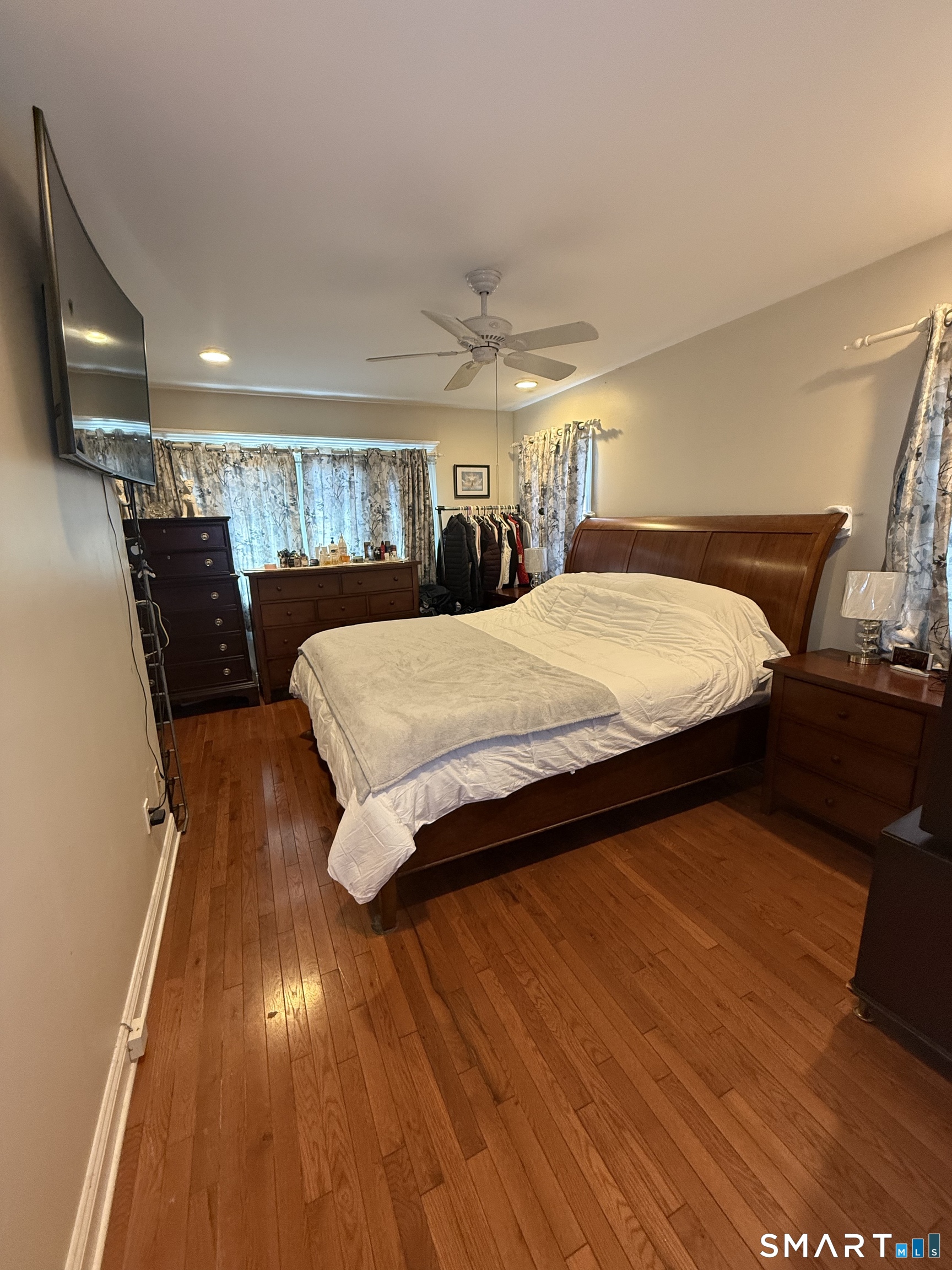 21 Mathew Street Milford, CT 06460 - Photo 16 of 28 a bedroom with a bed and wooden floor