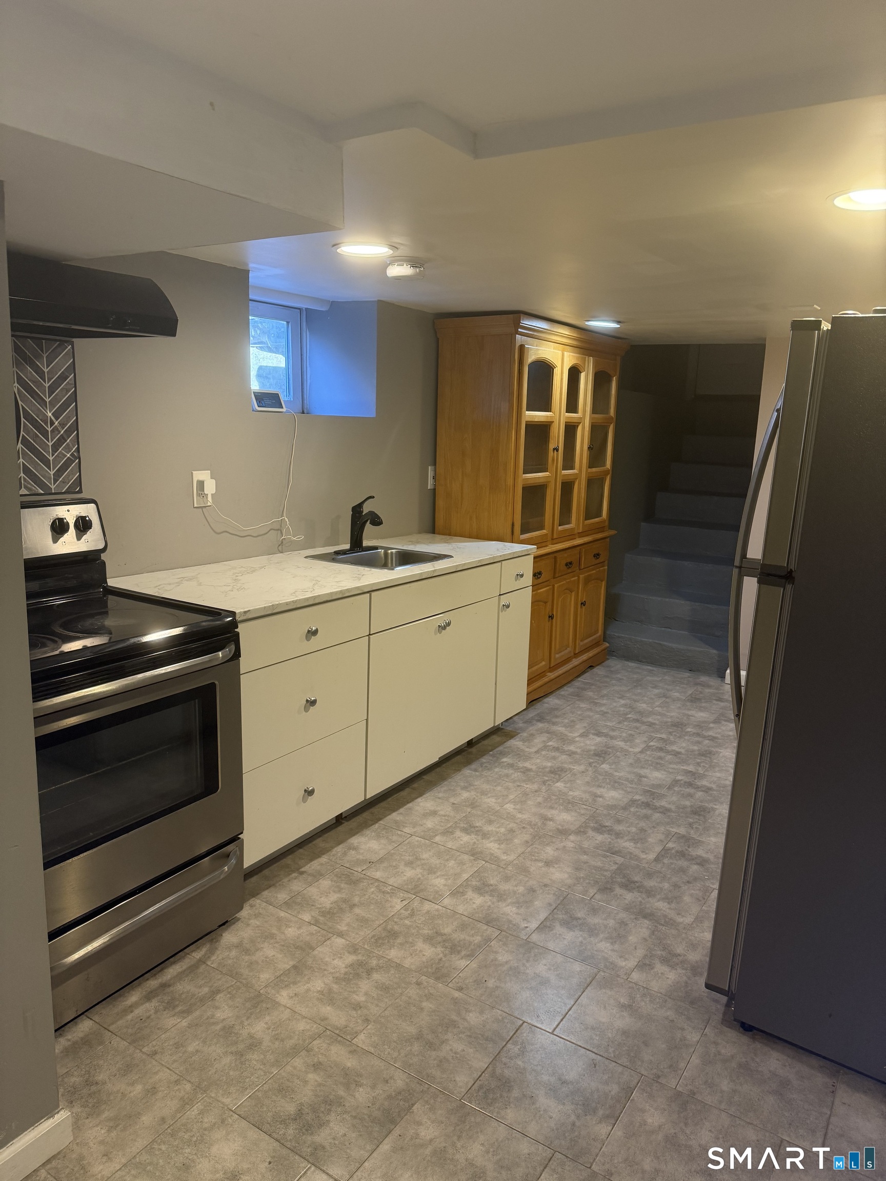 21 Mathew Street Milford, CT 06460 - Photo 22 of 28 a kitchen with a stove and a refrigerator
