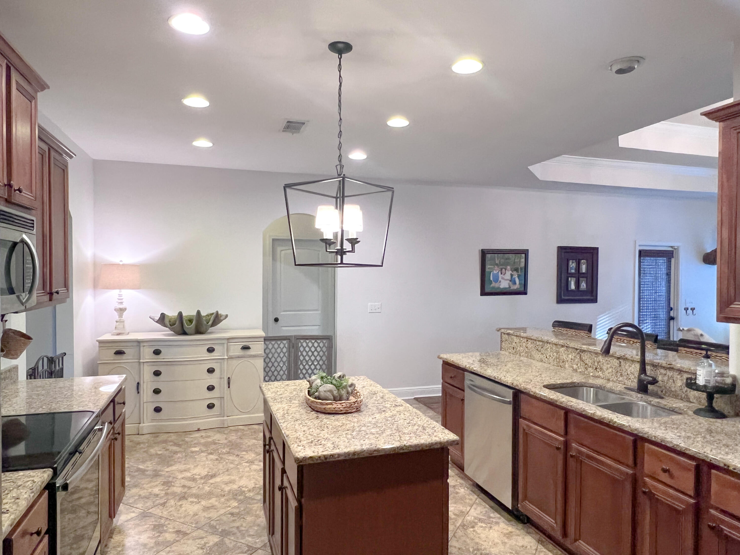 3362 Citrine Circle Crestview, FL 32539 - Photo 13 of 24 a kitchen with kitchen island granite countertop a sink stove and cabinets