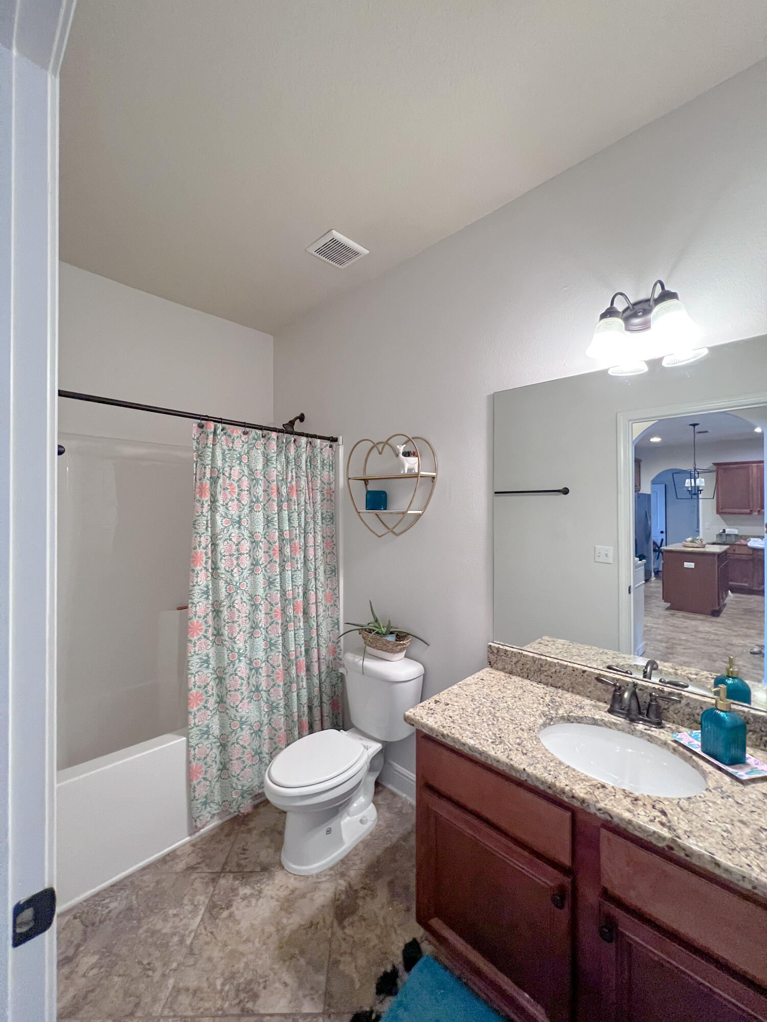 3362 Citrine Circle Crestview, FL 32539 - Photo 18 of 24 a bathroom with a granite countertop sink toilet a mirror a bathtub and shower