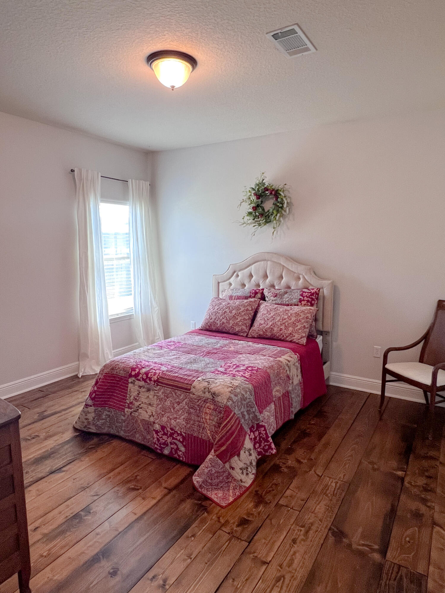 3362 Citrine Circle Crestview, FL 32539 - Photo 19 of 24 a bedroom with a bed and wooden floor