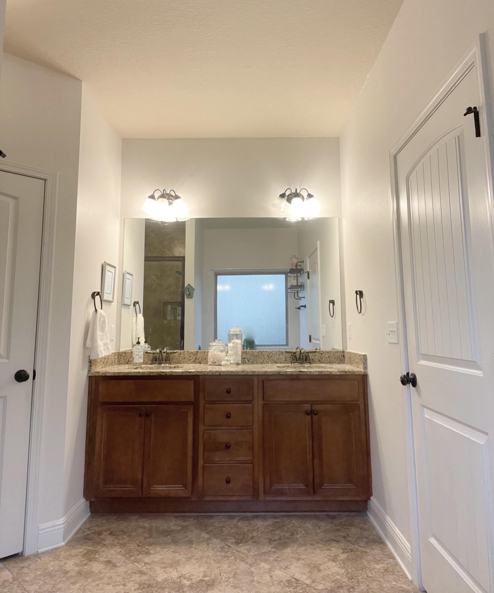 3362 Citrine Circle Crestview, FL 32539 - Photo 6 of 24 a bathroom with a granite countertop sink and a mirror