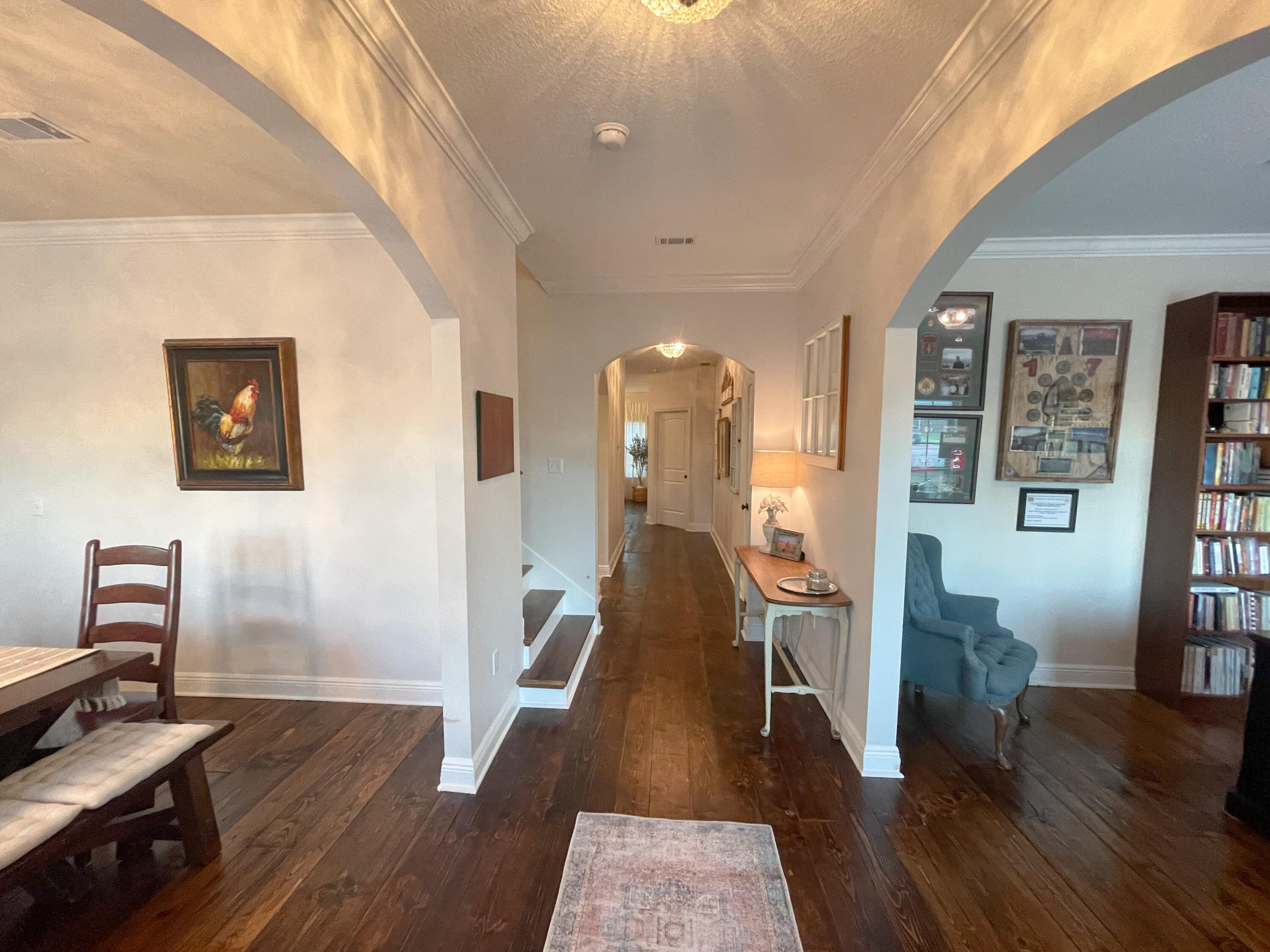 3362 Citrine Circle Crestview, FL 32539 - Photo 8 of 24 a view of a hallway with wooden floor and furniture