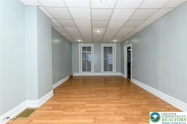 a view of empty room with wooden floor